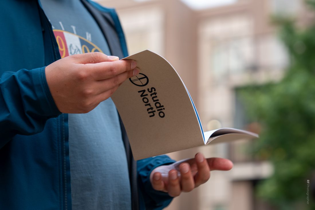 A Studio North pamphlet in hand at the event.